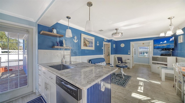 kitchen featuring dishwasher, sink, white cabinets, hanging light fixtures, and ornamental molding