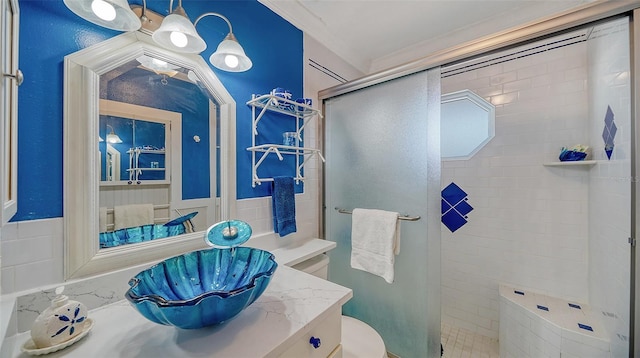 bathroom featuring ornamental molding, toilet, and walk in shower