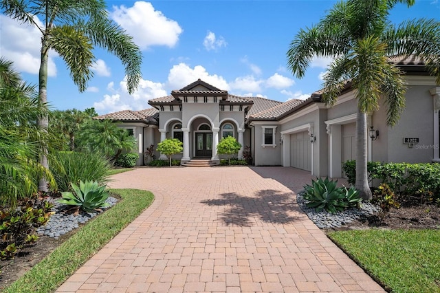 mediterranean / spanish-style house with a garage