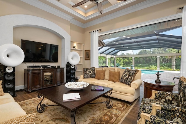 living room featuring dark hardwood / wood-style flooring, ornamental molding, and ceiling fan