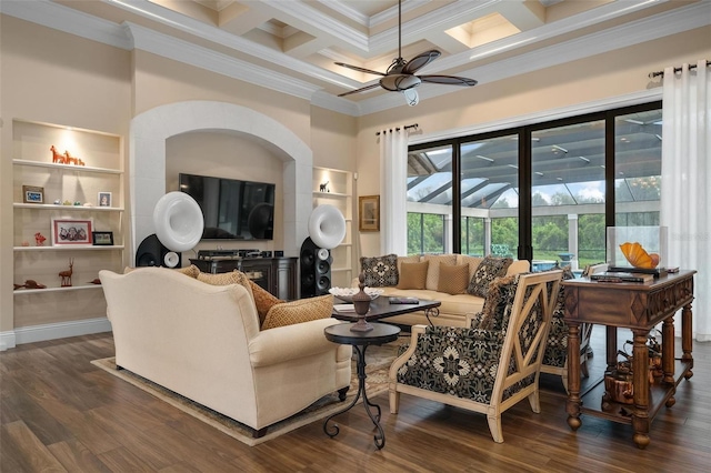 living room with beamed ceiling, ornamental molding, coffered ceiling, ceiling fan, and dark wood-type flooring