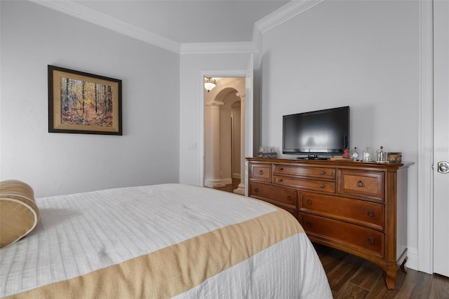 bedroom with dark hardwood / wood-style flooring, ornamental molding, and decorative columns