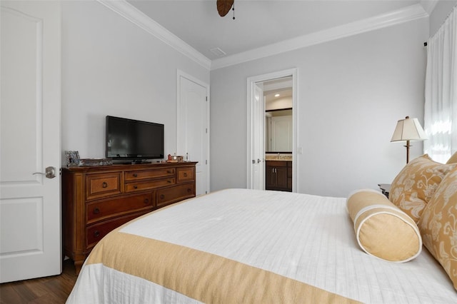 bedroom with crown molding, dark wood-type flooring, ceiling fan, and ensuite bathroom