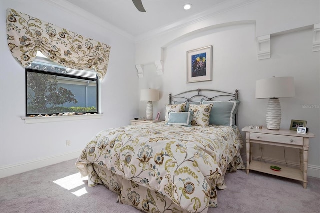 carpeted bedroom featuring ceiling fan and ornamental molding