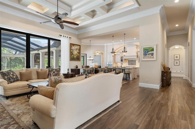 living room with beamed ceiling, hardwood / wood-style flooring, coffered ceiling, ceiling fan, and crown molding