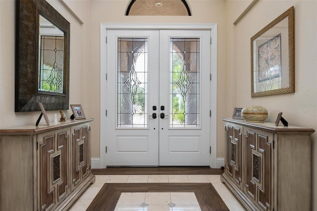 doorway to outside featuring light tile patterned floors and french doors