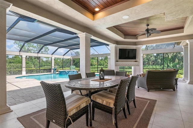 view of patio / terrace featuring a swimming pool with hot tub, a lanai, and ceiling fan