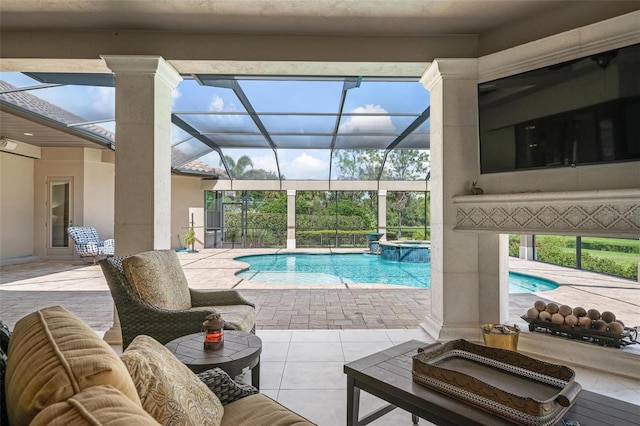 view of pool featuring an in ground hot tub, a lanai, and a patio area