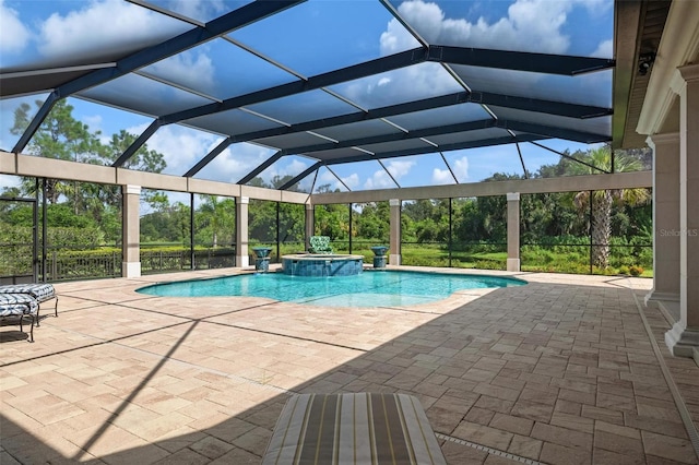 view of pool featuring an in ground hot tub, a patio, and glass enclosure