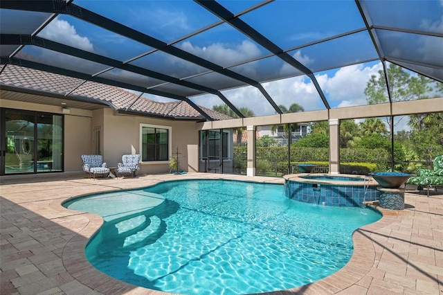 view of pool featuring an in ground hot tub, a lanai, pool water feature, and a patio area