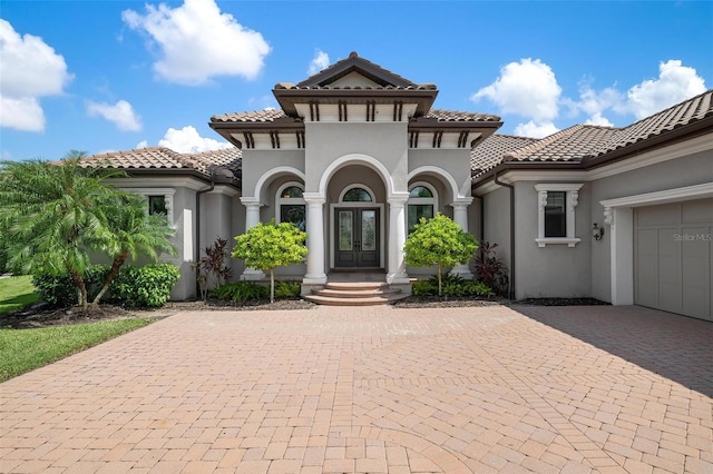 mediterranean / spanish home with a garage