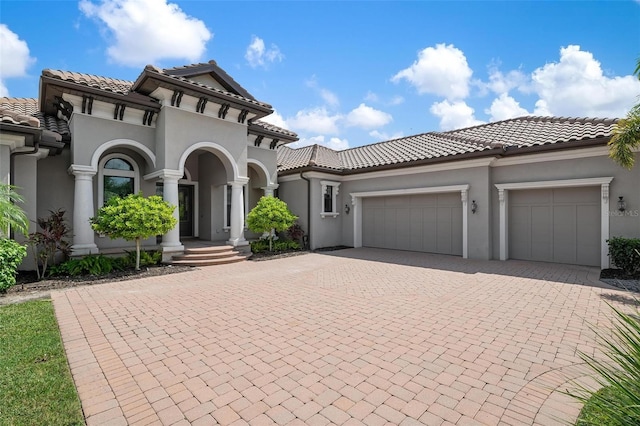 mediterranean / spanish-style house with a garage