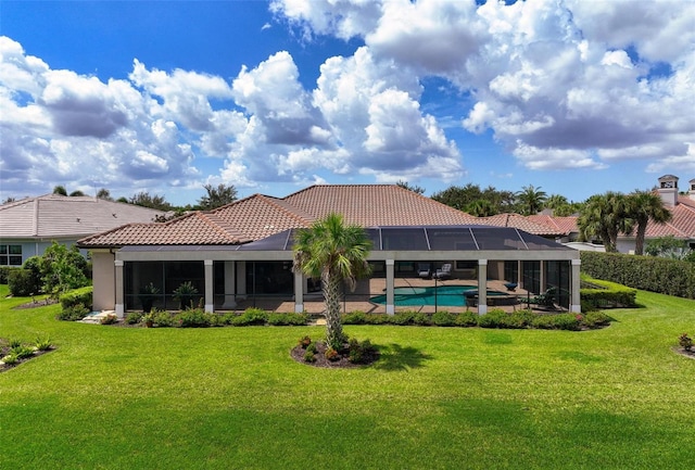 back of property featuring a lawn and glass enclosure