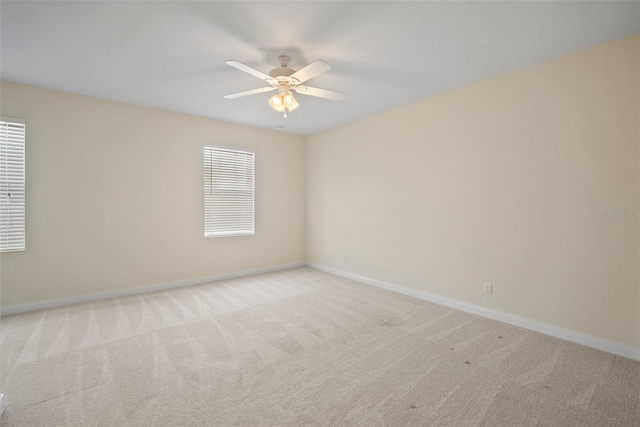 empty room featuring light colored carpet and ceiling fan