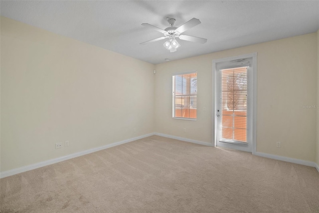 carpeted empty room featuring ceiling fan