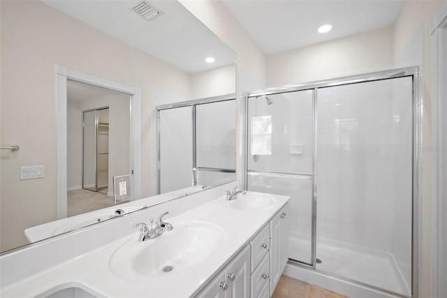 bathroom featuring vanity and a shower with door