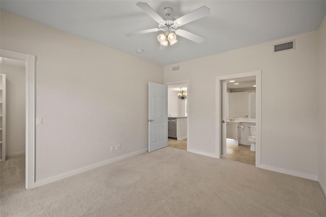 unfurnished bedroom featuring connected bathroom, light colored carpet, and ceiling fan