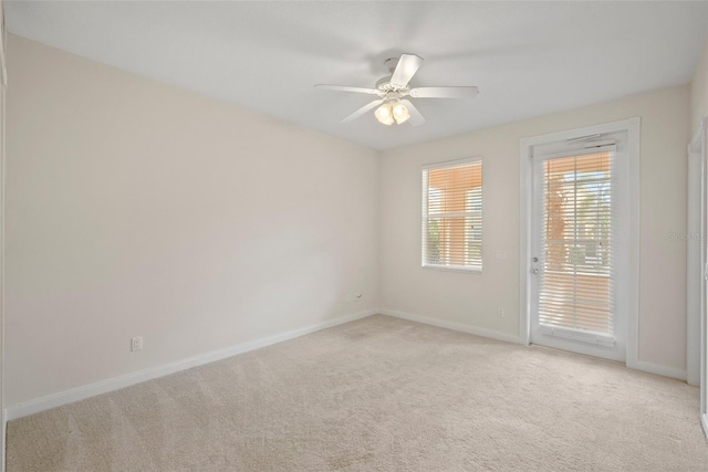 unfurnished room with ceiling fan and light carpet