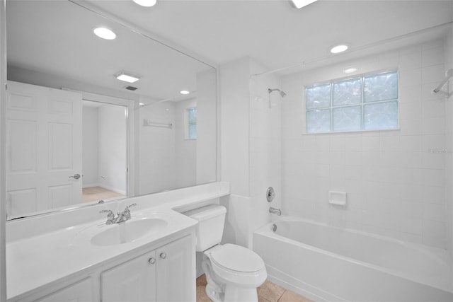 full bathroom featuring a healthy amount of sunlight, vanity, toilet, and tiled shower / bath combo