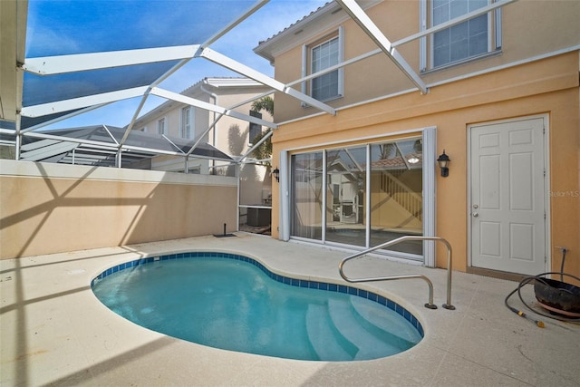 view of swimming pool featuring a patio and glass enclosure