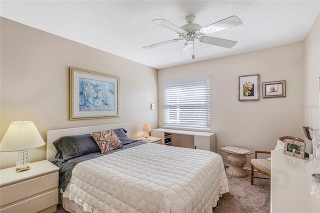 carpeted bedroom with ceiling fan and a textured ceiling