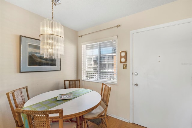 dining room featuring hardwood / wood-style floors and a notable chandelier