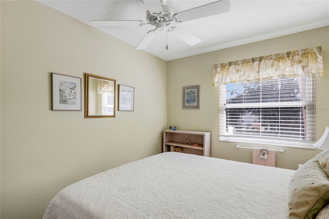 bedroom featuring a textured ceiling and ceiling fan