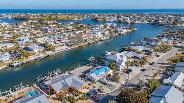 bird's eye view featuring a water view and a residential view