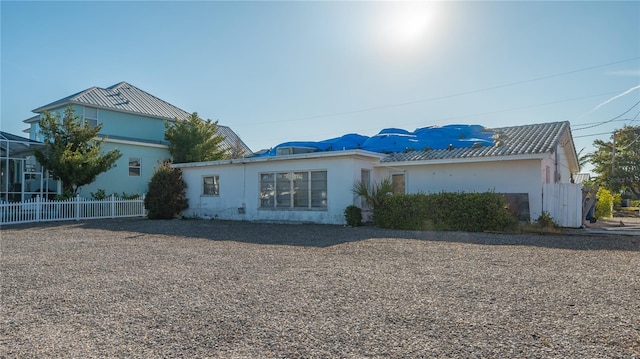 view of front facade featuring fence and stucco siding