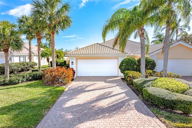 view of front of property with a garage and a front lawn