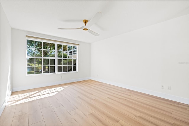 spare room with ceiling fan and light wood-type flooring