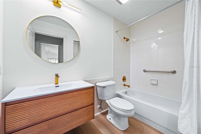 full bathroom featuring shower / tub combo with curtain, vanity, hardwood / wood-style flooring, and toilet