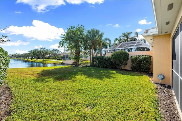 view of yard featuring a water view and a lanai