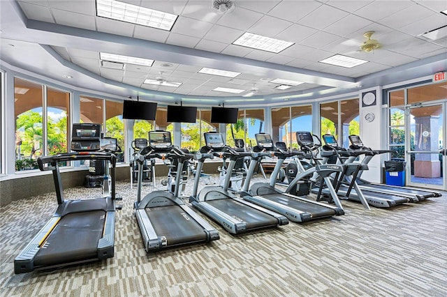 workout area with carpet flooring, a wealth of natural light, and a drop ceiling