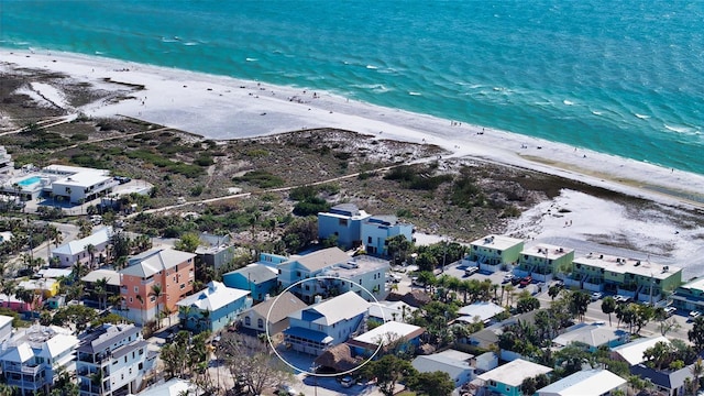 birds eye view of property featuring a water view and a beach view