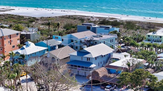 drone / aerial view featuring a view of the beach and a water view