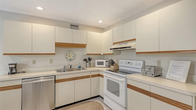 kitchen featuring sink, a textured ceiling, white cabinets, and white appliances