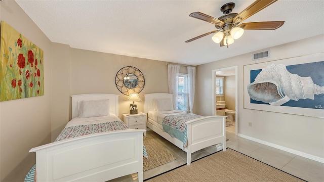 tiled bedroom with a textured ceiling and ceiling fan