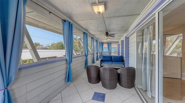 sunroom with ceiling fan and a healthy amount of sunlight