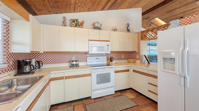 kitchen with lofted ceiling, sink, tasteful backsplash, white appliances, and white cabinets