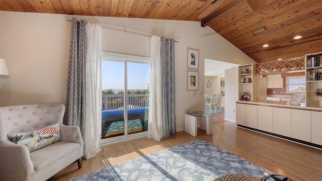 living area featuring vaulted ceiling with beams, wooden ceiling, and light wood-type flooring