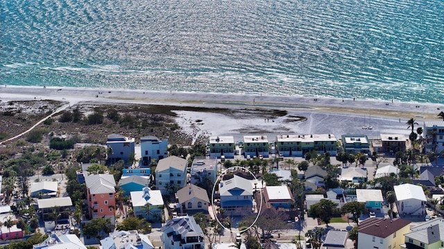 birds eye view of property with a water view and a view of the beach