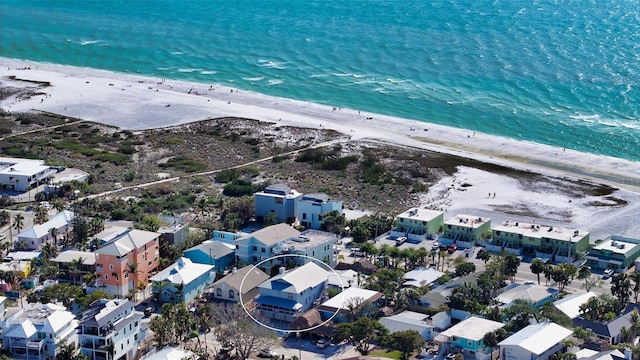 birds eye view of property with a water view and a beach view