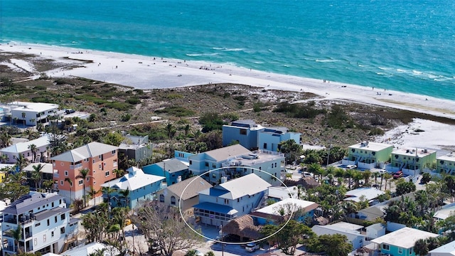 drone / aerial view with a water view and a view of the beach