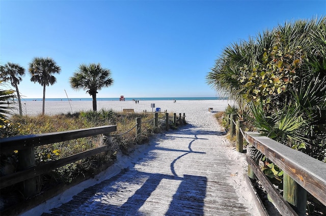 surrounding community featuring a water view and a view of the beach