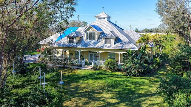 view of front of property with a porch and a front lawn