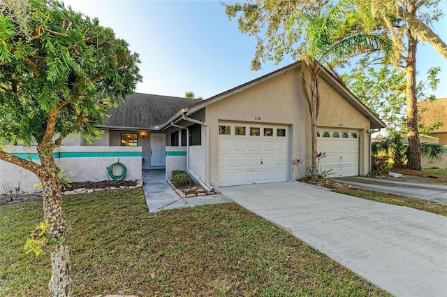 ranch-style house with a garage and a front lawn