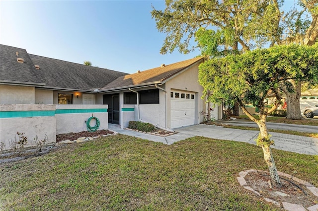 ranch-style house featuring a garage, a sunroom, and a front lawn