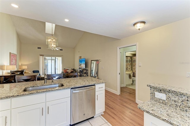 kitchen featuring sink, dishwasher, white cabinetry, light stone countertops, and decorative light fixtures