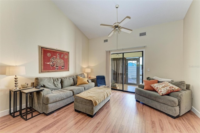 living room featuring ceiling fan, high vaulted ceiling, and light hardwood / wood-style floors